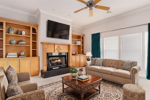 living room featuring ceiling fan, ornamental molding, and a fireplace