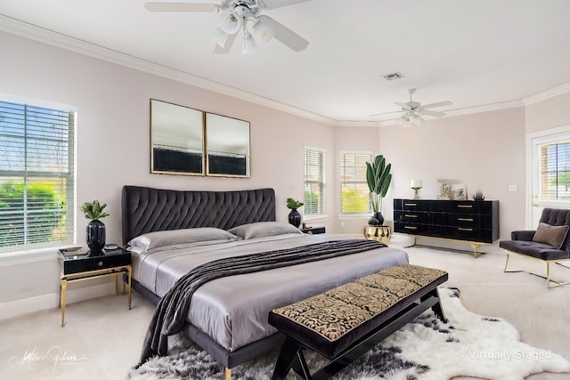 carpeted bedroom featuring ceiling fan and ornamental molding