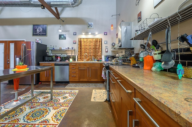 kitchen featuring appliances with stainless steel finishes, a towering ceiling, island range hood, decorative light fixtures, and sink