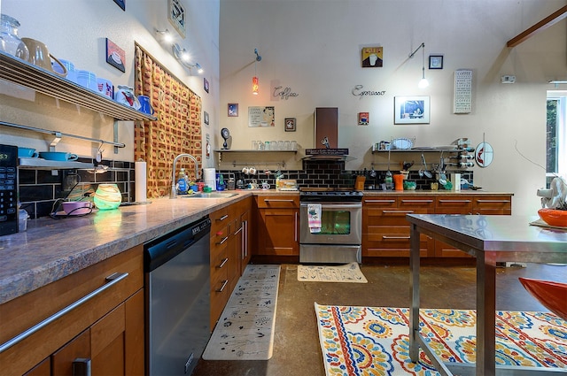 kitchen with appliances with stainless steel finishes, sink, decorative backsplash, and wall chimney range hood