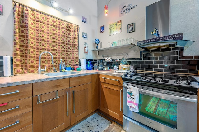 kitchen featuring stainless steel stove, sink, decorative backsplash, hanging light fixtures, and wall chimney range hood