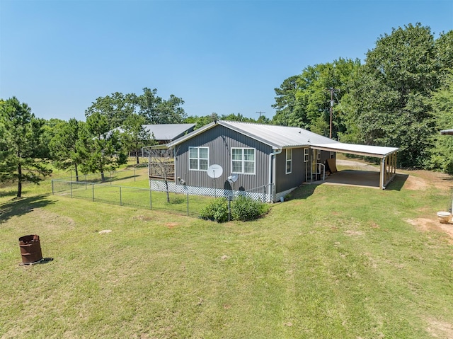 view of side of home featuring a yard and a carport