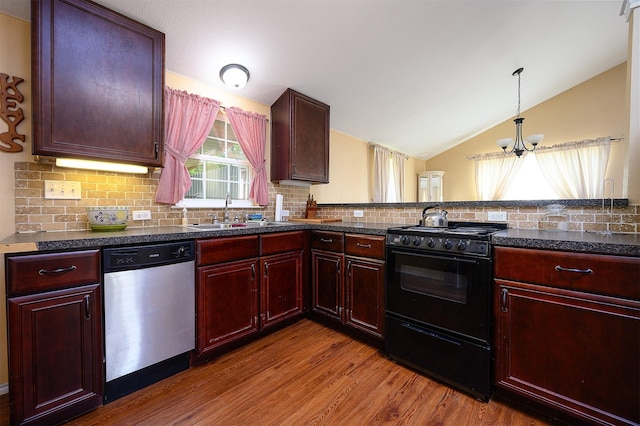 kitchen with black gas range oven, lofted ceiling, sink, hardwood / wood-style flooring, and stainless steel dishwasher