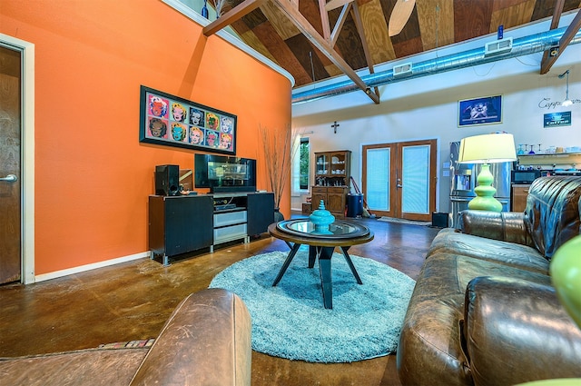 living room with french doors and a towering ceiling