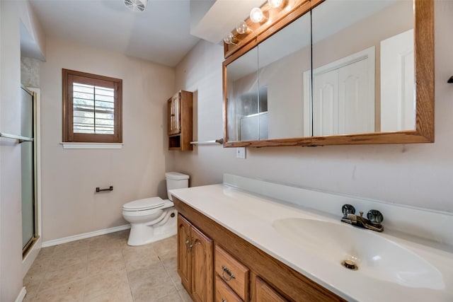 bathroom featuring tile patterned floors, vanity, toilet, and walk in shower