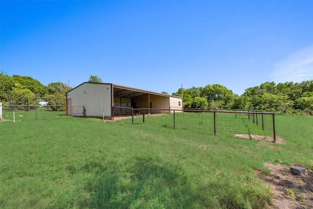 view of yard with a rural view and an outdoor structure