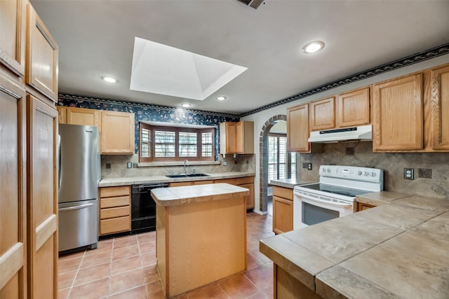 kitchen featuring a healthy amount of sunlight, a kitchen island, white electric range oven, and black dishwasher