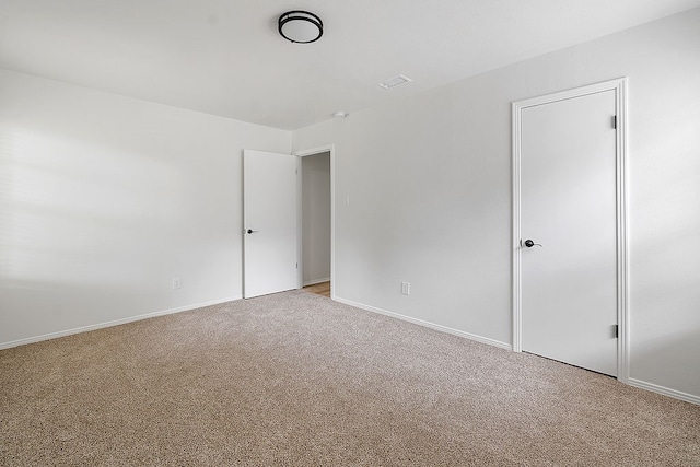 unfurnished room with light carpet