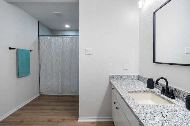 bathroom with vanity and hardwood / wood-style flooring