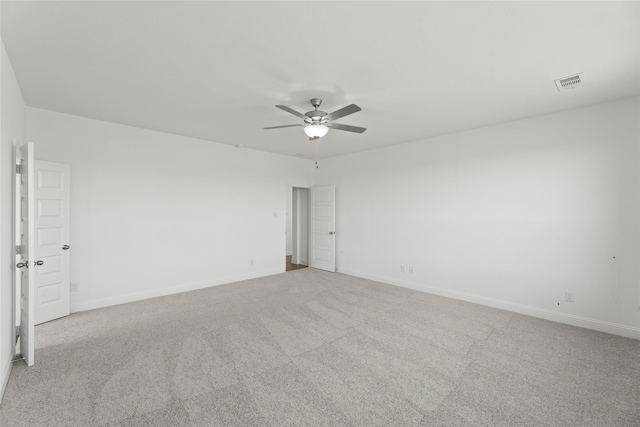 unfurnished room featuring light colored carpet and ceiling fan