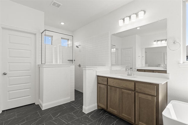 full bathroom with marble finish floor, visible vents, vanity, a walk in shower, and baseboards