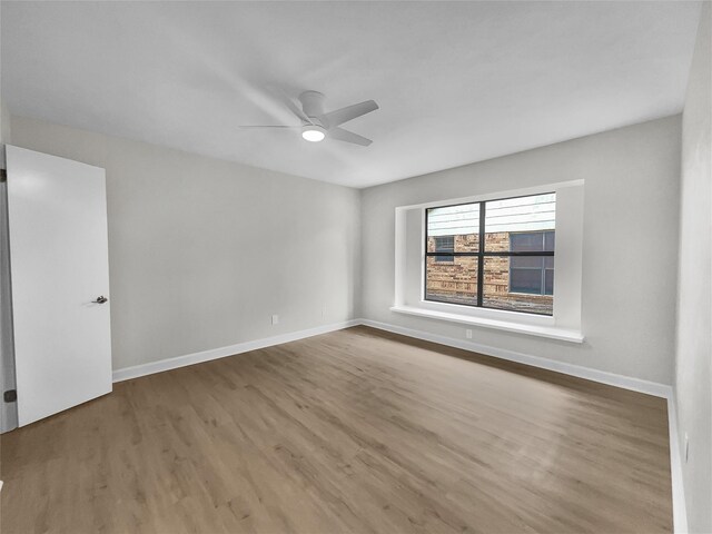 unfurnished room featuring ceiling fan and wood-type flooring