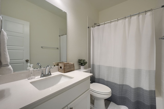 bathroom with curtained shower, vanity, and toilet