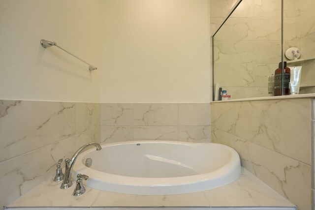 bathroom with a tub to relax in