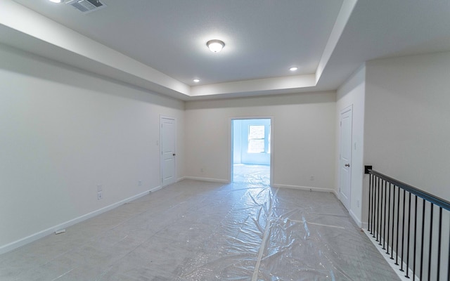 unfurnished room with a tray ceiling