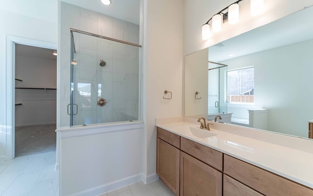 bathroom featuring a shower with door, tile flooring, and vanity