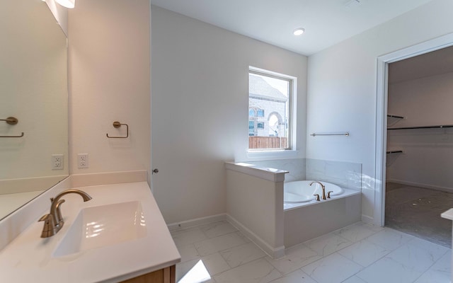 bathroom featuring a tub, tile flooring, and oversized vanity