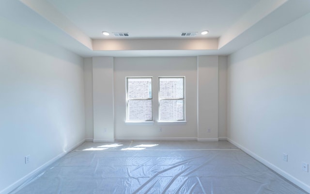 unfurnished room with a raised ceiling