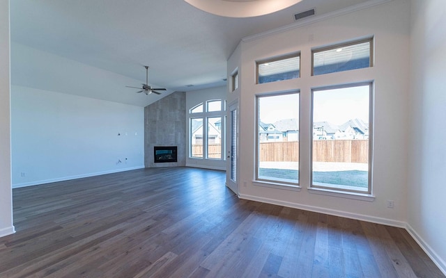 unfurnished living room with baseboards, a large fireplace, dark wood finished floors, and a ceiling fan