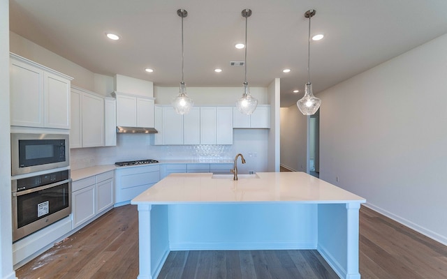 kitchen featuring hardwood / wood-style floors, tasteful backsplash, black microwave, oven, and white cabinets