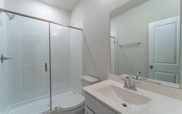 bathroom featuring an enclosed shower, toilet, and large vanity