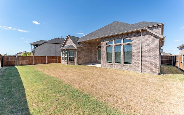 rear view of house featuring a lawn