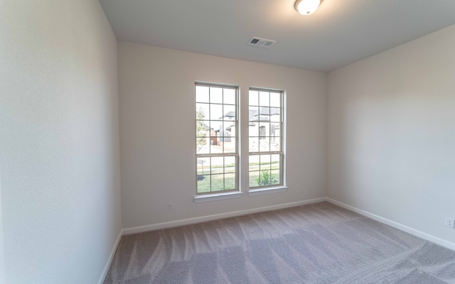 unfurnished room featuring carpet