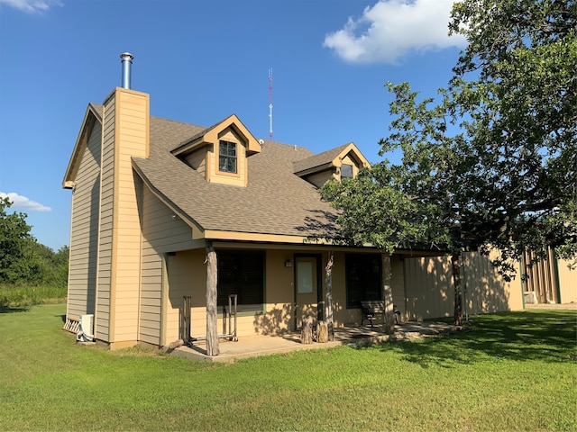 view of front facade with a front lawn and a patio area