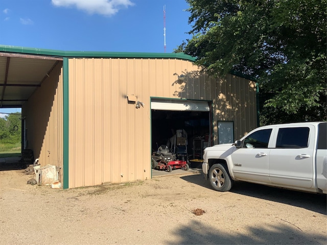 view of home's exterior with a garage and an outdoor structure