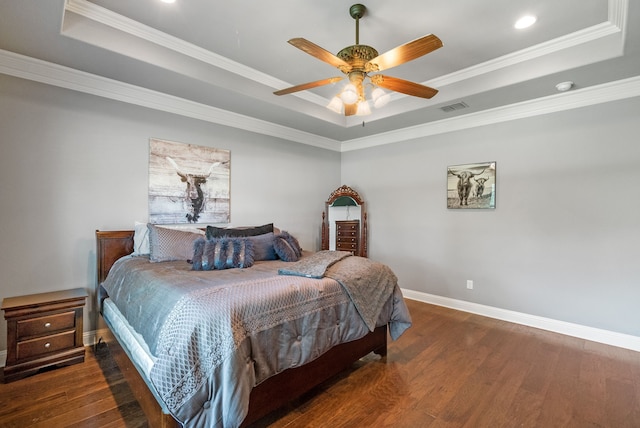 bedroom featuring a tray ceiling, ceiling fan, crown molding, and dark hardwood / wood-style floors