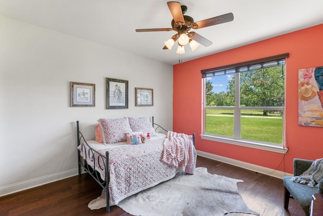 bedroom with ceiling fan and dark wood-type flooring