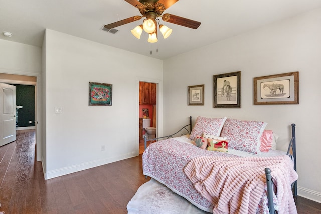 bedroom featuring dark hardwood / wood-style floors, ceiling fan, and connected bathroom