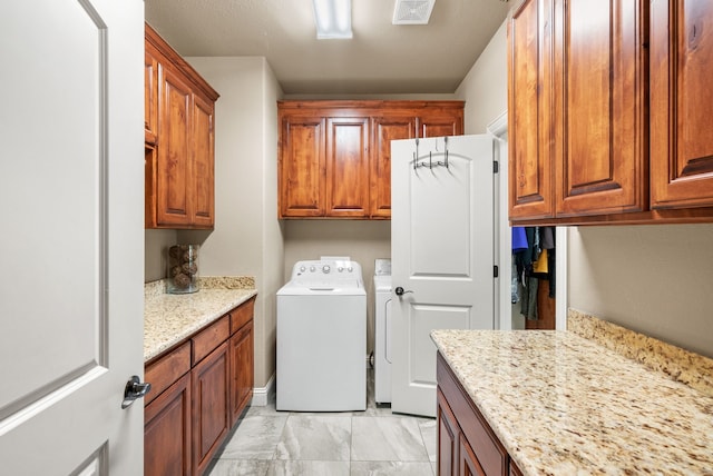 laundry area with washer and dryer and cabinets