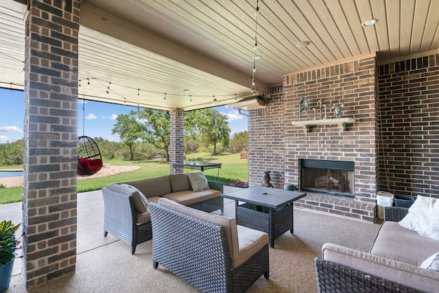 view of patio featuring an outdoor living space with a fireplace