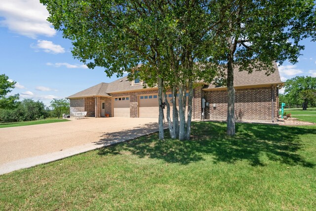 view of front of house with a garage and a front lawn