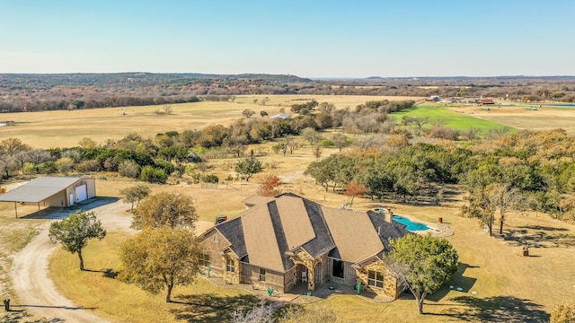 birds eye view of property with a rural view