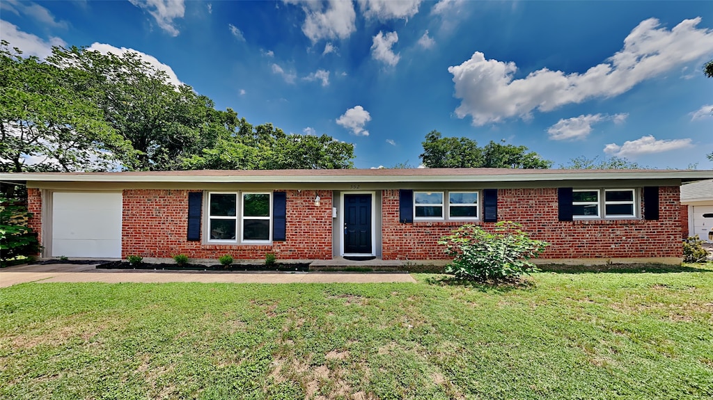 ranch-style house with a garage and a front lawn