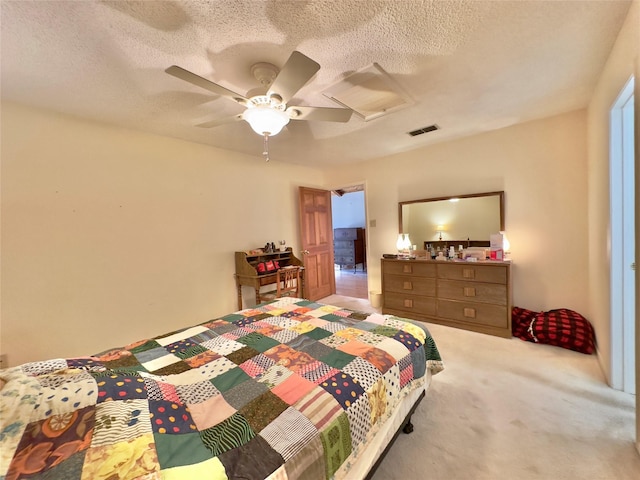 bedroom featuring ceiling fan, carpet floors, and a textured ceiling