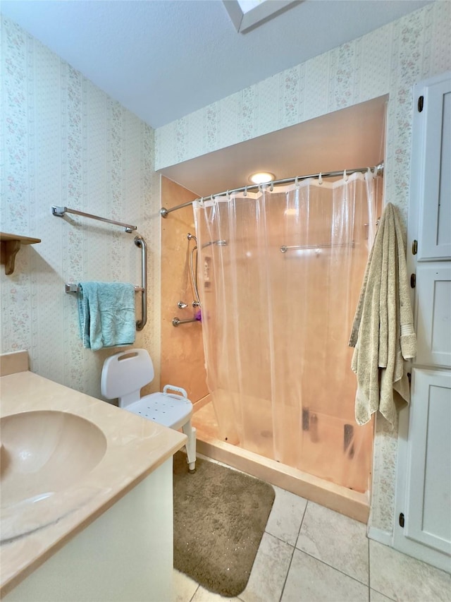 bathroom featuring a shower with curtain, tile patterned flooring, and vanity