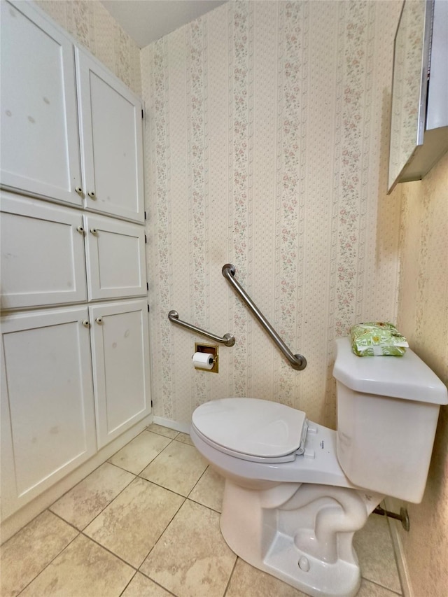 bathroom featuring tile patterned flooring and toilet