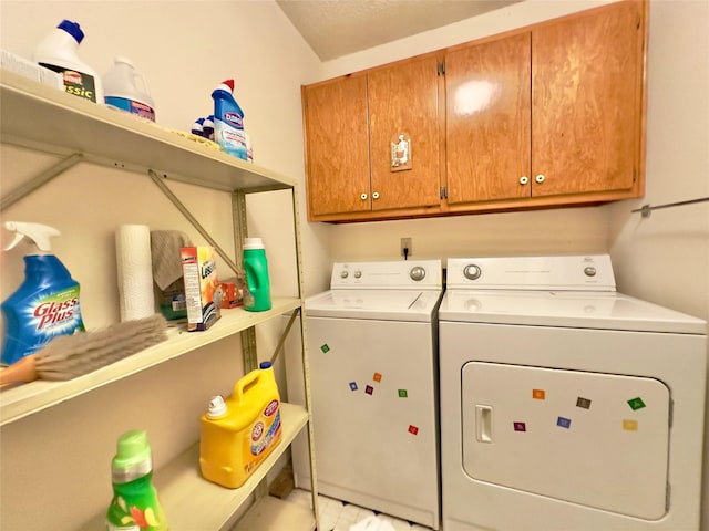 laundry room featuring cabinets and washing machine and clothes dryer