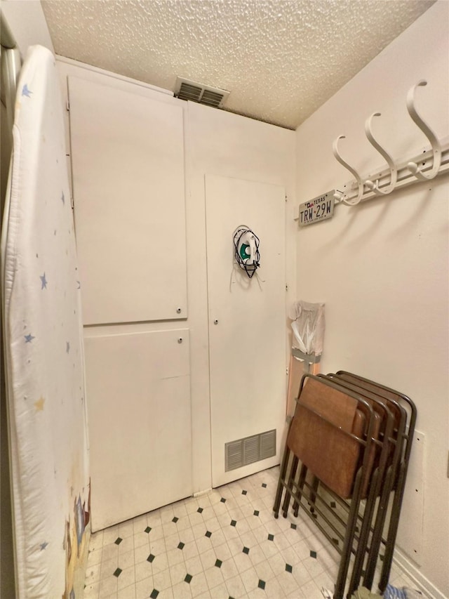 bathroom with a textured ceiling