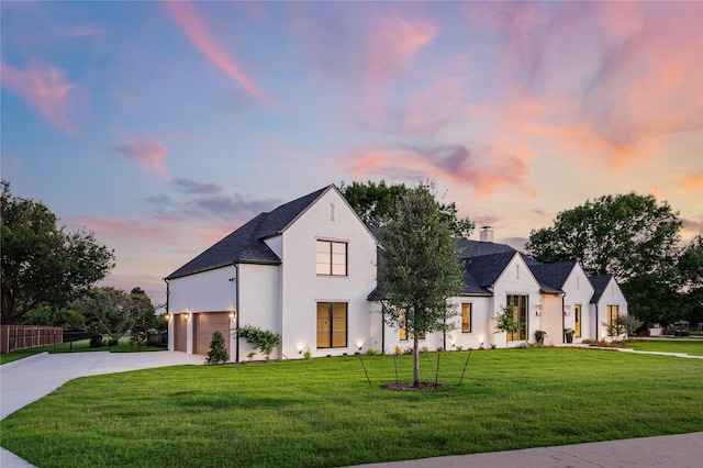 view of front of house with a yard and a garage