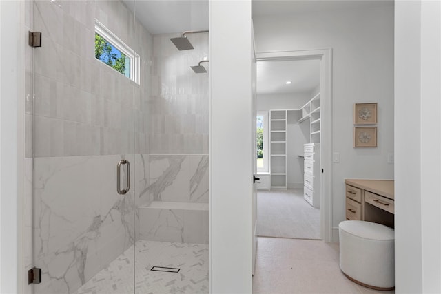 bathroom with plenty of natural light and a shower with door