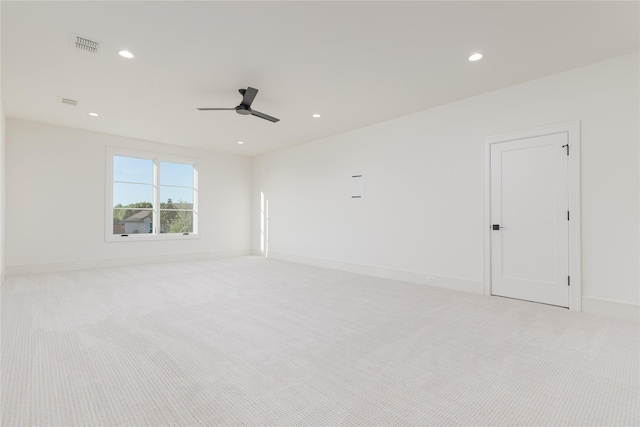 carpeted spare room with ceiling fan