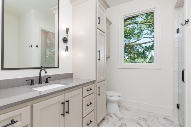 bathroom with vanity, toilet, and an enclosed shower