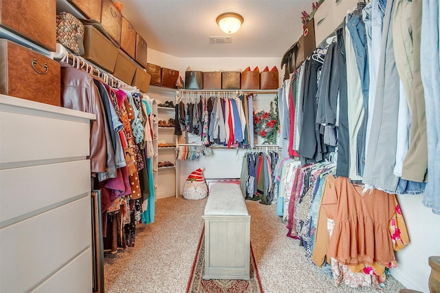 spacious closet with light carpet and visible vents