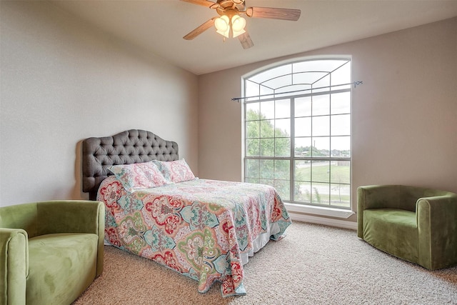 carpeted bedroom featuring vaulted ceiling and a ceiling fan