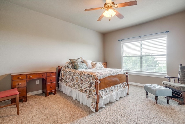 bedroom featuring baseboards, a ceiling fan, and light colored carpet