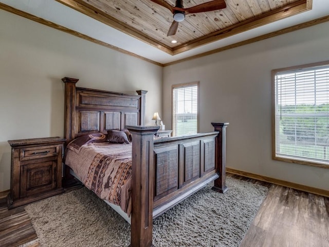 bedroom with a raised ceiling, crown molding, ceiling fan, dark hardwood / wood-style floors, and wood ceiling